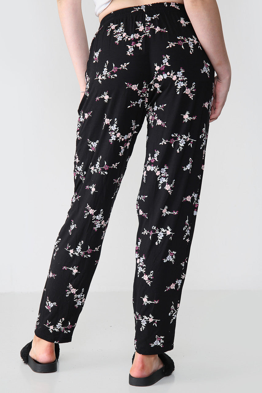 GEELASTICEERDE BROEK MET BLOEMENBOEKETPRINT ZWART/ROZE