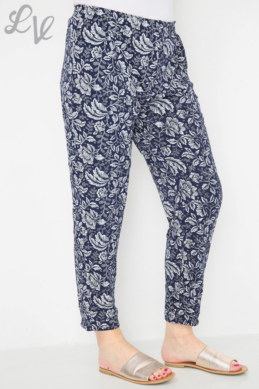 Navy leaf-outline print tapered trousers with elastic waist