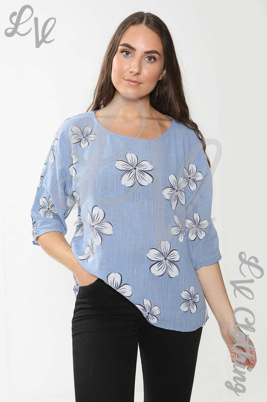 Blue ladies top with white daisy print, three-quarter sleeves and round neckline