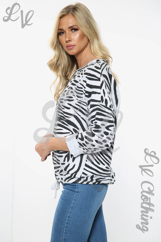 Zebra print tie-waist top with long sleeves, white base and black animal pattern