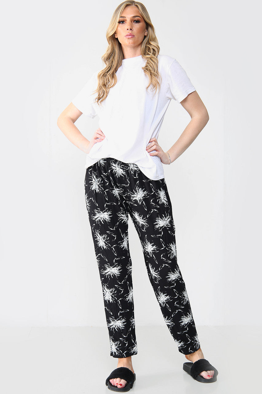 GEEL ELASTISCHE BROEK MET PAARDENBLOEMENPRINT ZWART