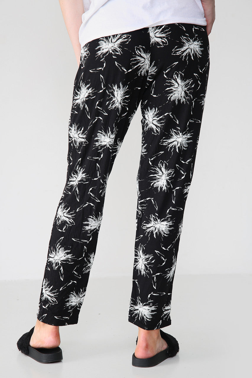 GEEL ELASTISCHE BROEK MET PAARDENBLOEMENPRINT ZWART