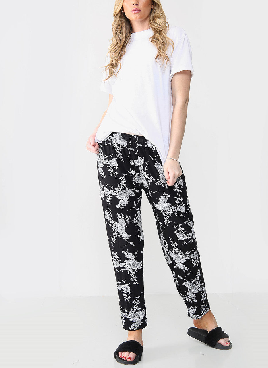 ELASTISCHE BROEK MET BLOEMENPRINT ZWART