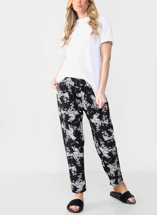 ELASTISCHE BROEK MET BLOEMENPRINT ZWART