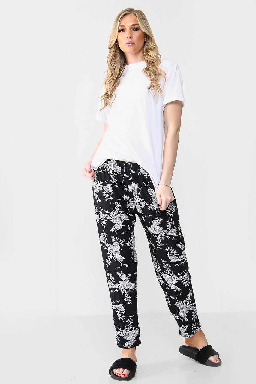 ELASTISCHE BROEK MET BLOEMENPRINT ZWART