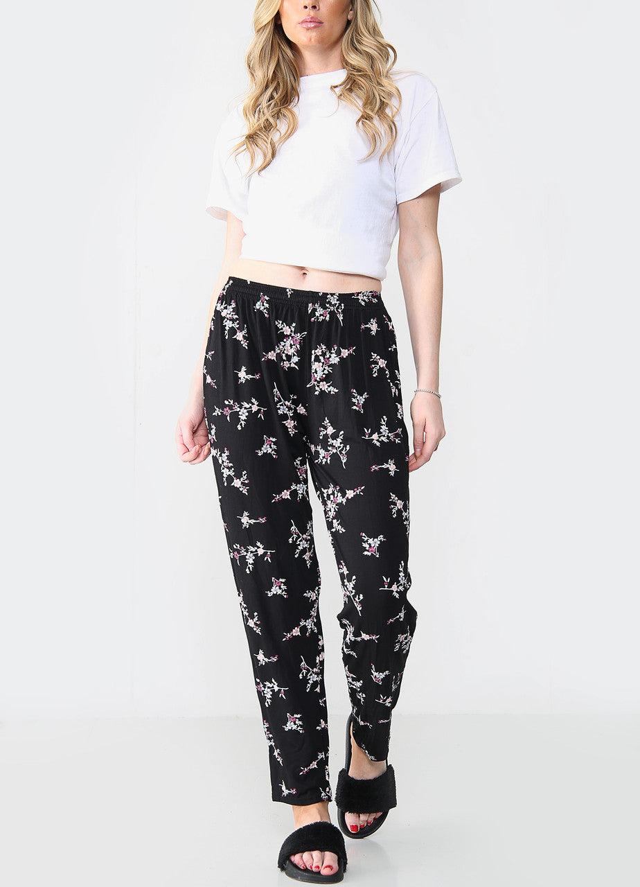 GEELASTICEERDE BROEK MET BLOEMENBOEKETPRINT ZWART/ROZE