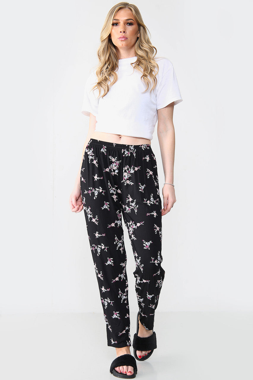 GEELASTICEERDE BROEK MET BLOEMENBOEKETPRINT ZWART/ROZE