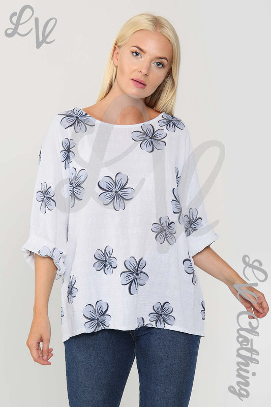 White floral print blouse with blue daisy flowers, loose fit and wide sleeves