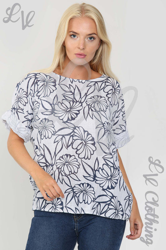 White ladies top with navy floral outline print, short sleeves and round neckline