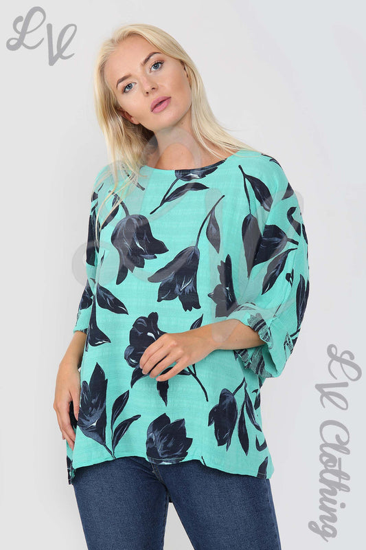 Women's turquoise tulip print top with black floral design, relaxed fit, 3/4 sleeves