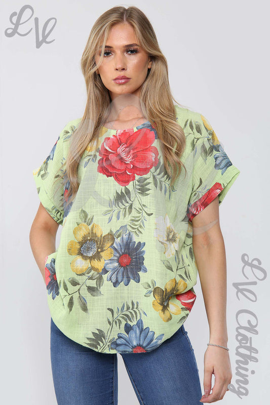 Chartreuse floral print top with large red flower, short sleeves, front view