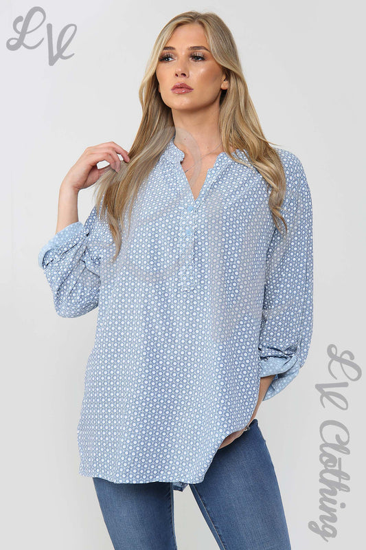 Light blue small hexagon print grandad-style blouse with long sleeves and V neckline