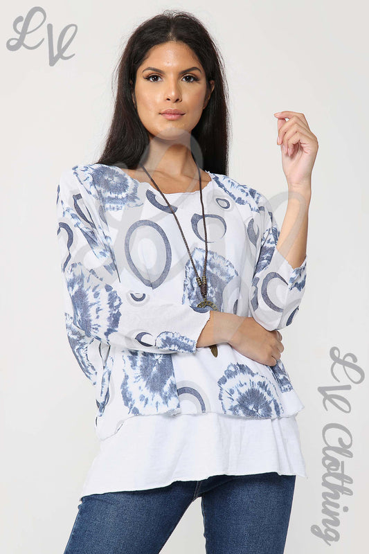 White tunic top with blue circle tie-dye print, long sleeves, with necklace pendant