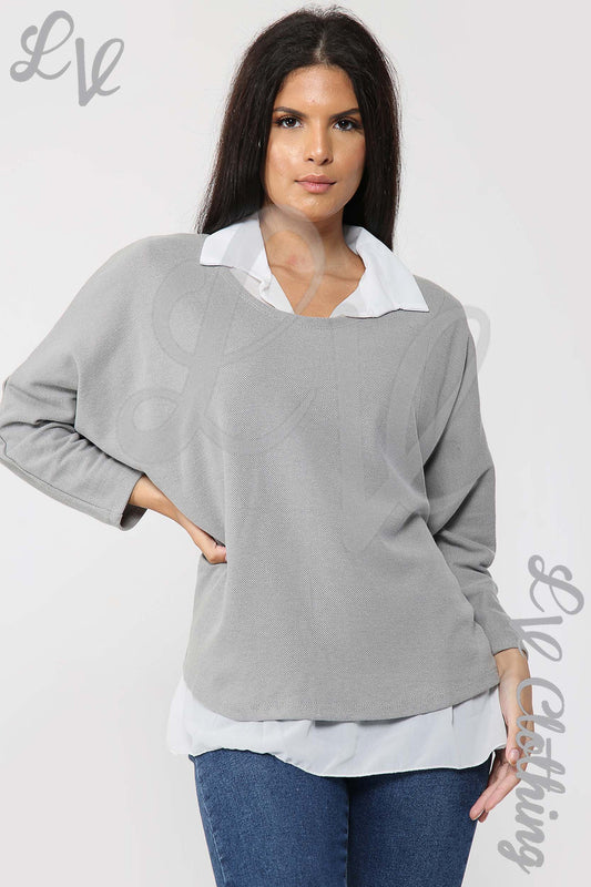 Grey long-sleeve layered blouse with white collared underlayer hem