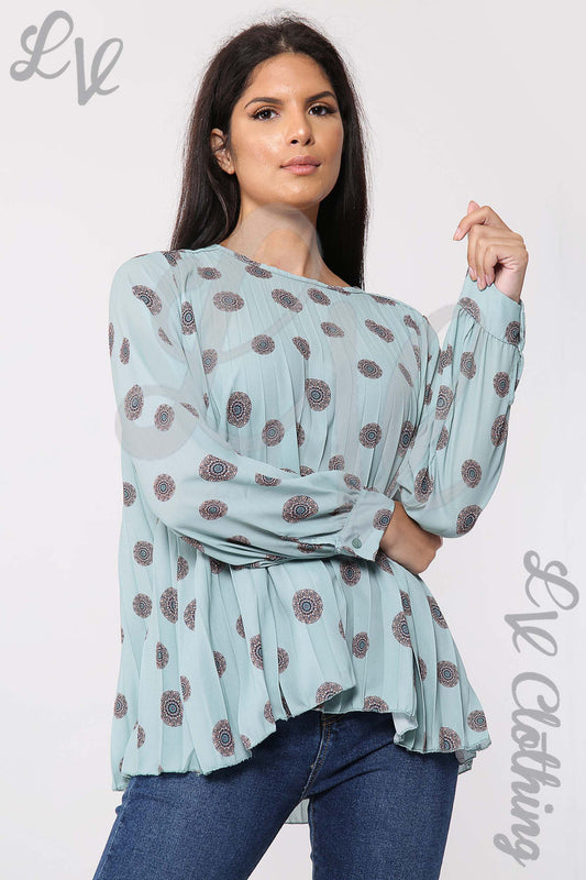 Light teal pleated blouse with long sleeves and circular tribal print