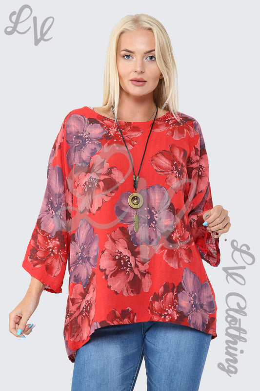 Red floral print blouse with long sleeves and pendant necklace