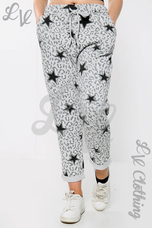 Leopard-print jogger pants with black stars, elastic waistband, ankle cuffs