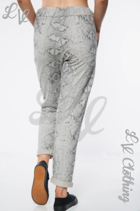 Taupe snake-print jogger pants with elastic cuffs and drawstring waist