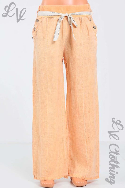 Orange linen trousers with elasticated waist and drawstring, button pocket detail