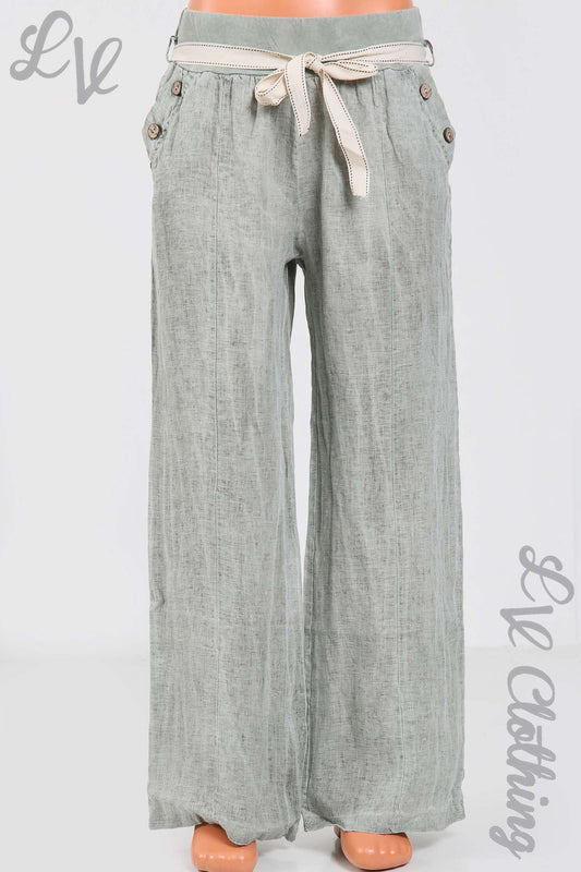 Light khaki linen trousers with elastic waist, tie belt and button pocket details