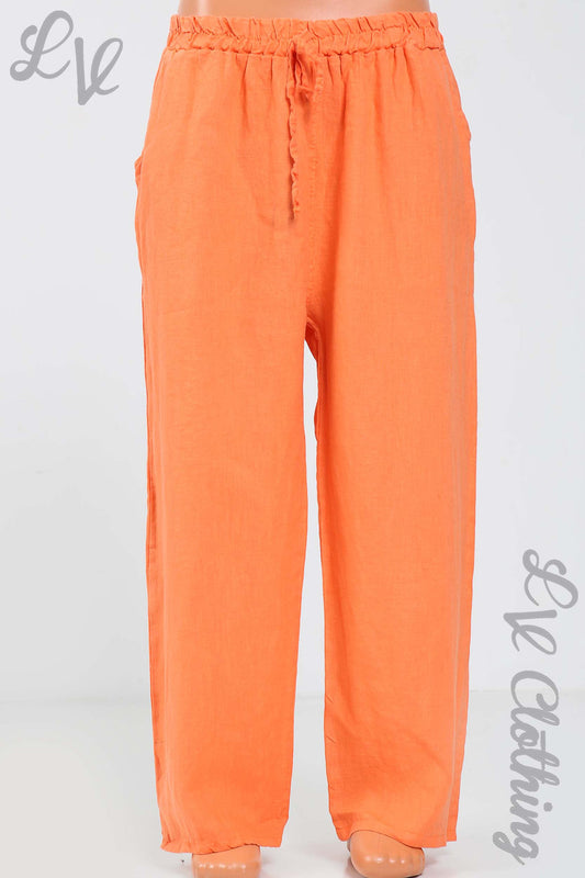 Orange linen trousers with elastic waist and drawstring, ankle-length