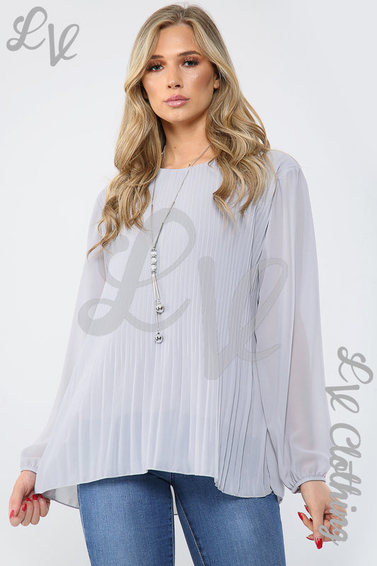 Light grey pleated long-sleeve blouse with tassel necklace and keyhole neckline