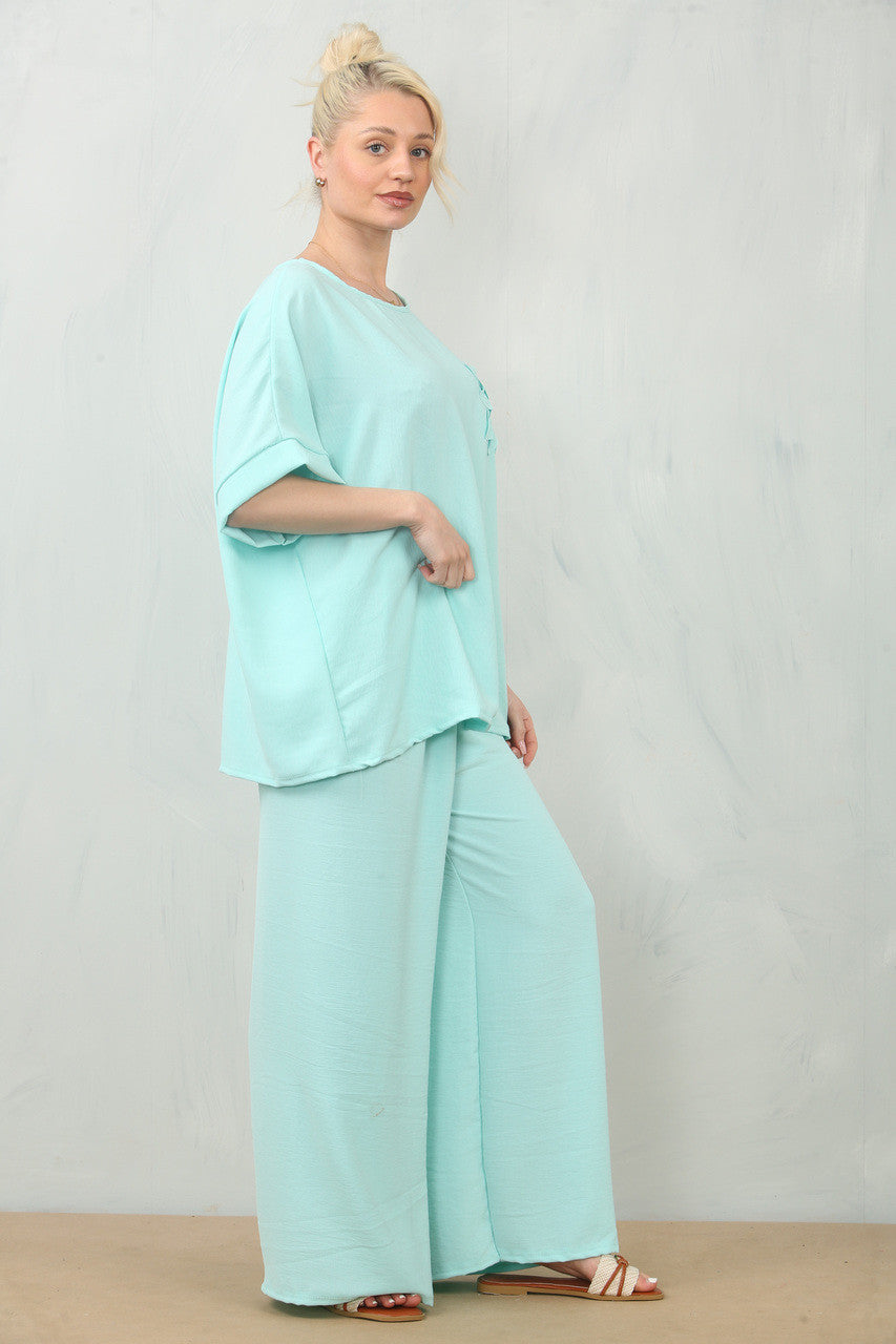 ZWEVENDE BLOEMENCORSAGE TOP & BROEK SET - MINT