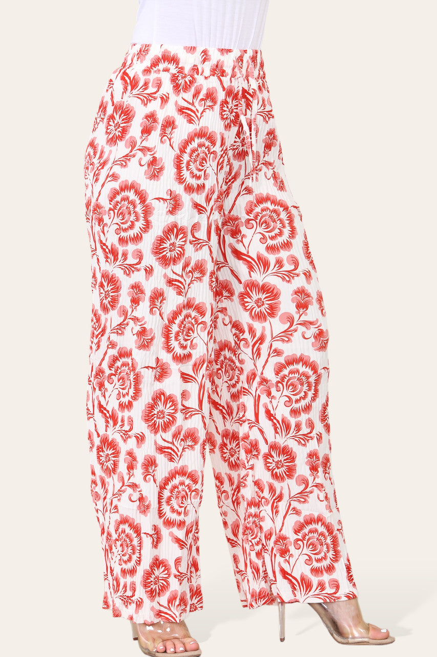 BROEK MET ELASTISCHE TAILLE, WIJDE PIJPEN, GEPLOOID EN MET BLOEMEN BAROKPRINT