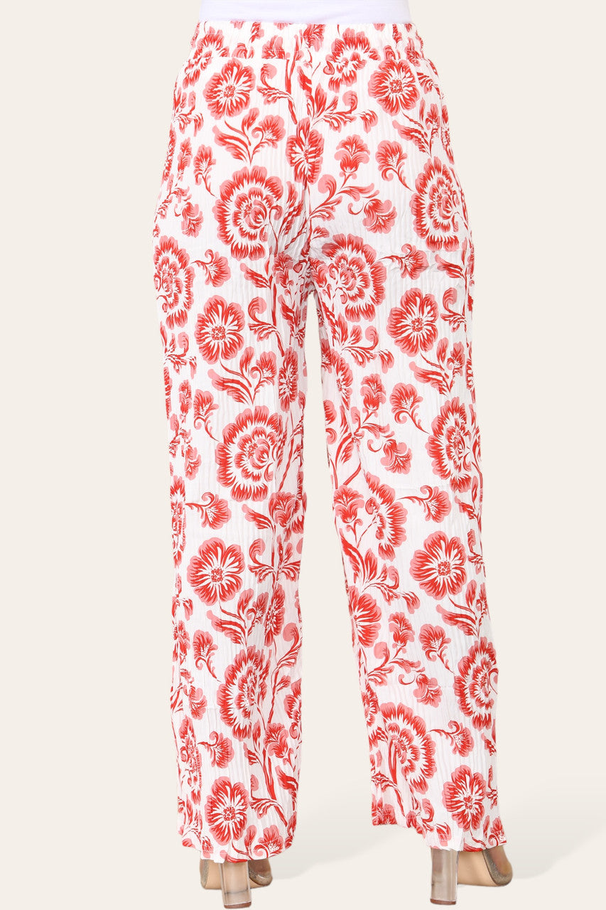 BROEK MET ELASTISCHE TAILLE, WIJDE PIJPEN, GEPLOOID EN MET BLOEMEN BAROKPRINT