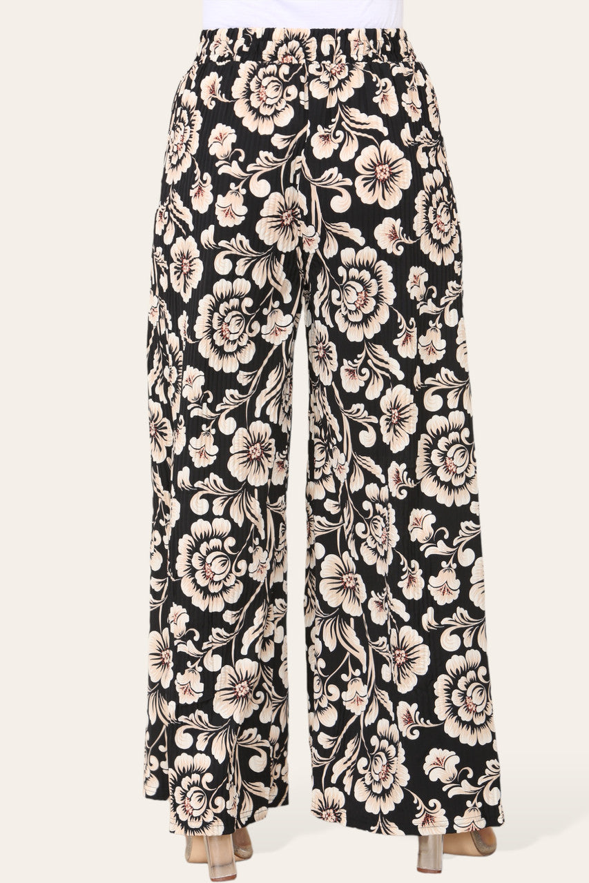 BROEK MET ELASTISCHE TAILLE, WIJDE PIJPEN, GEPLOOID EN MET BLOEMEN BAROKPRINT