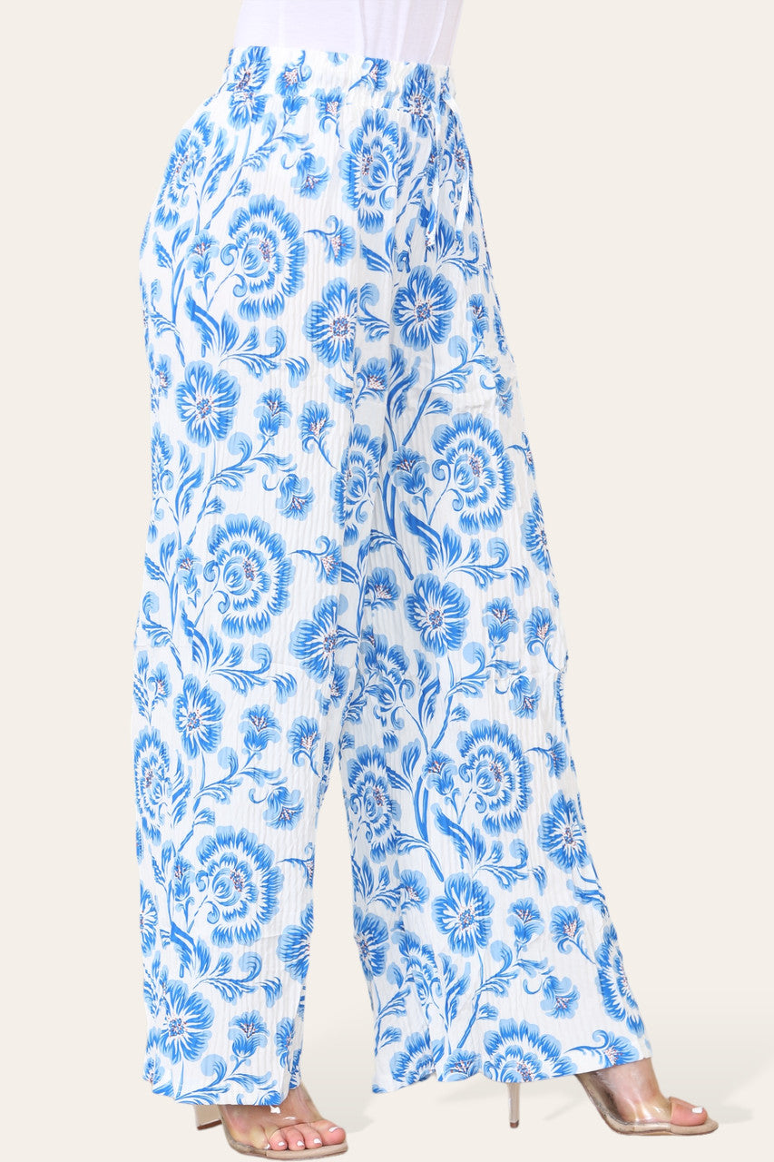 BROEK MET ELASTISCHE TAILLE, WIJDE PIJPEN, GEPLOOID EN MET BLOEMEN BAROKPRINT