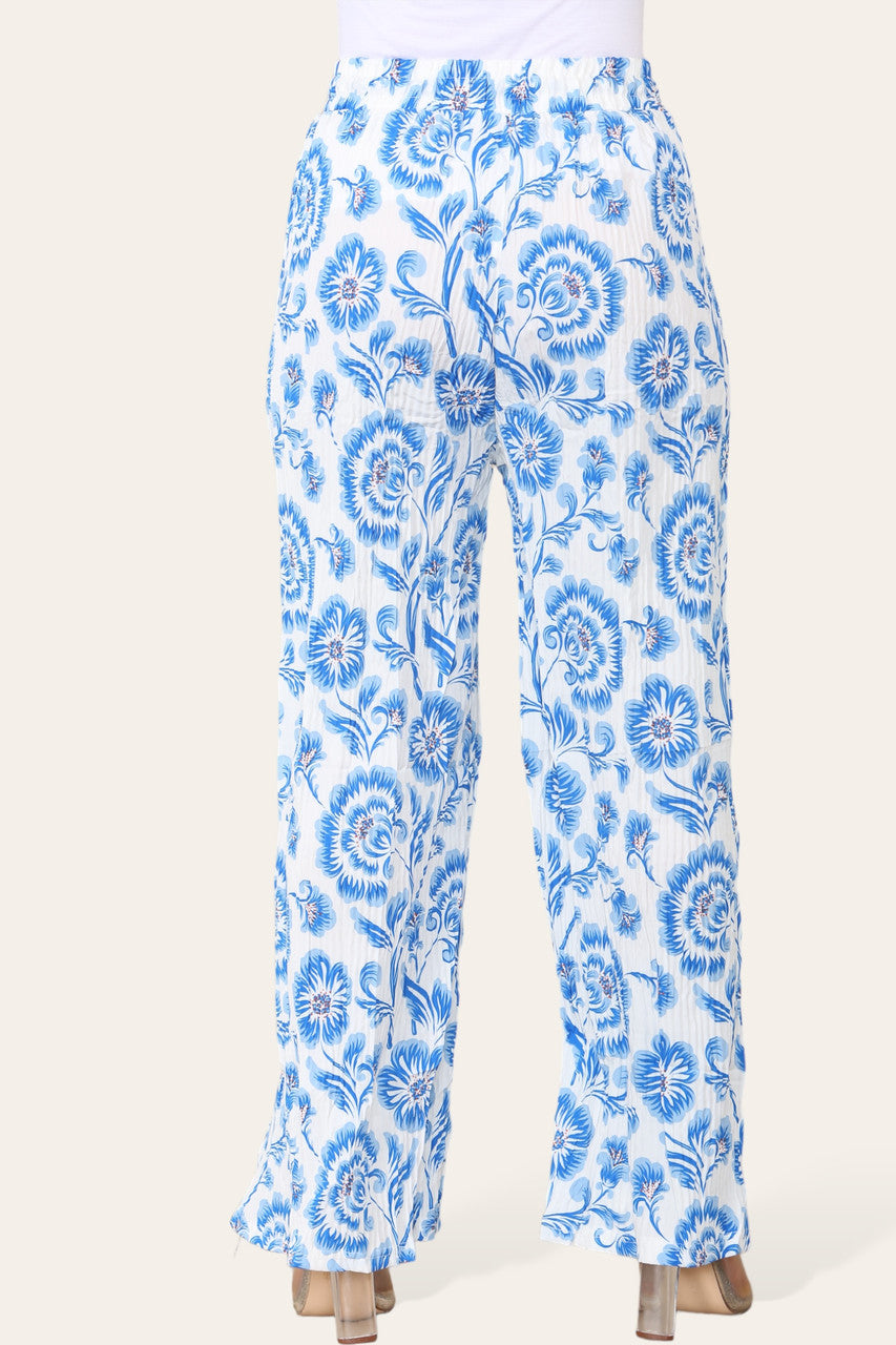 BROEK MET ELASTISCHE TAILLE, WIJDE PIJPEN, GEPLOOID EN MET BLOEMEN BAROKPRINT
