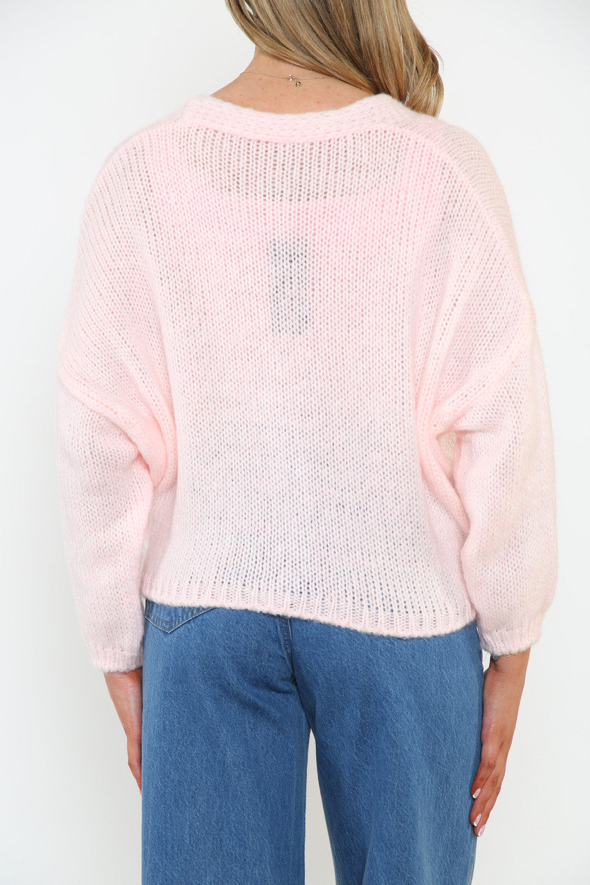 Dames pluizig gebreid vest met knopen aan de voorkant roze