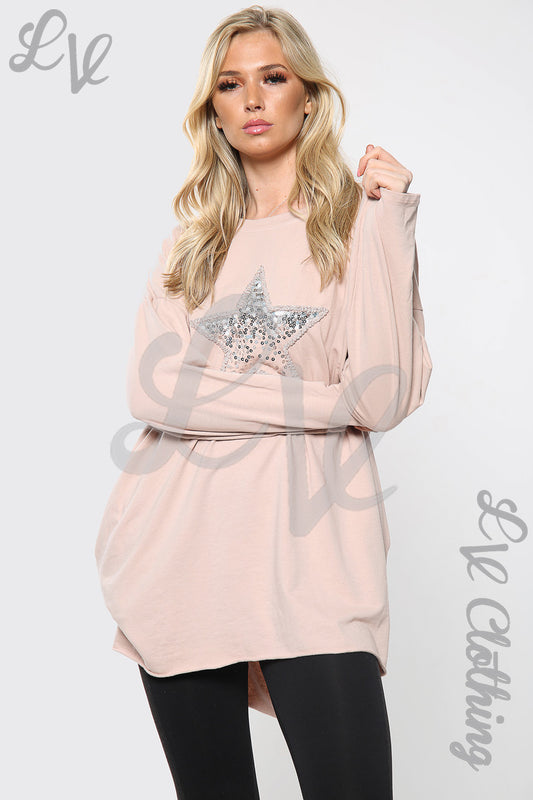 Dusty pink oversize top with silver sequin star print and long sleeves, relaxed fit