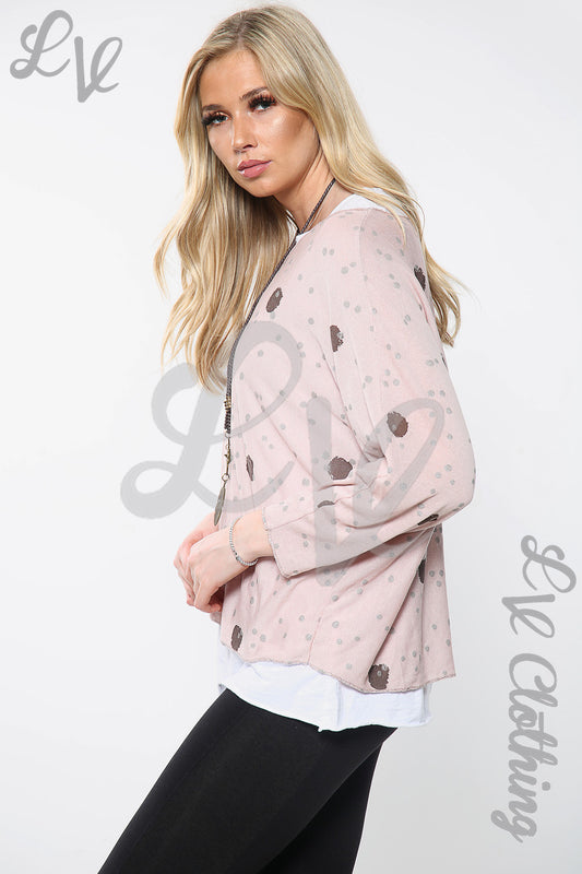 Dusty pink spot print twin-layer top with V-neck and long sleeves, worn with necklace