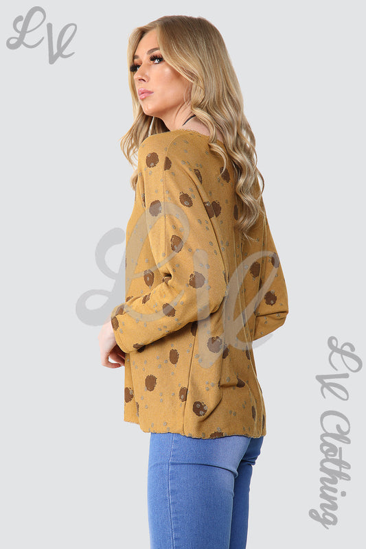 Mustard spot-print top with long sleeves and pendant necklace, round neckline