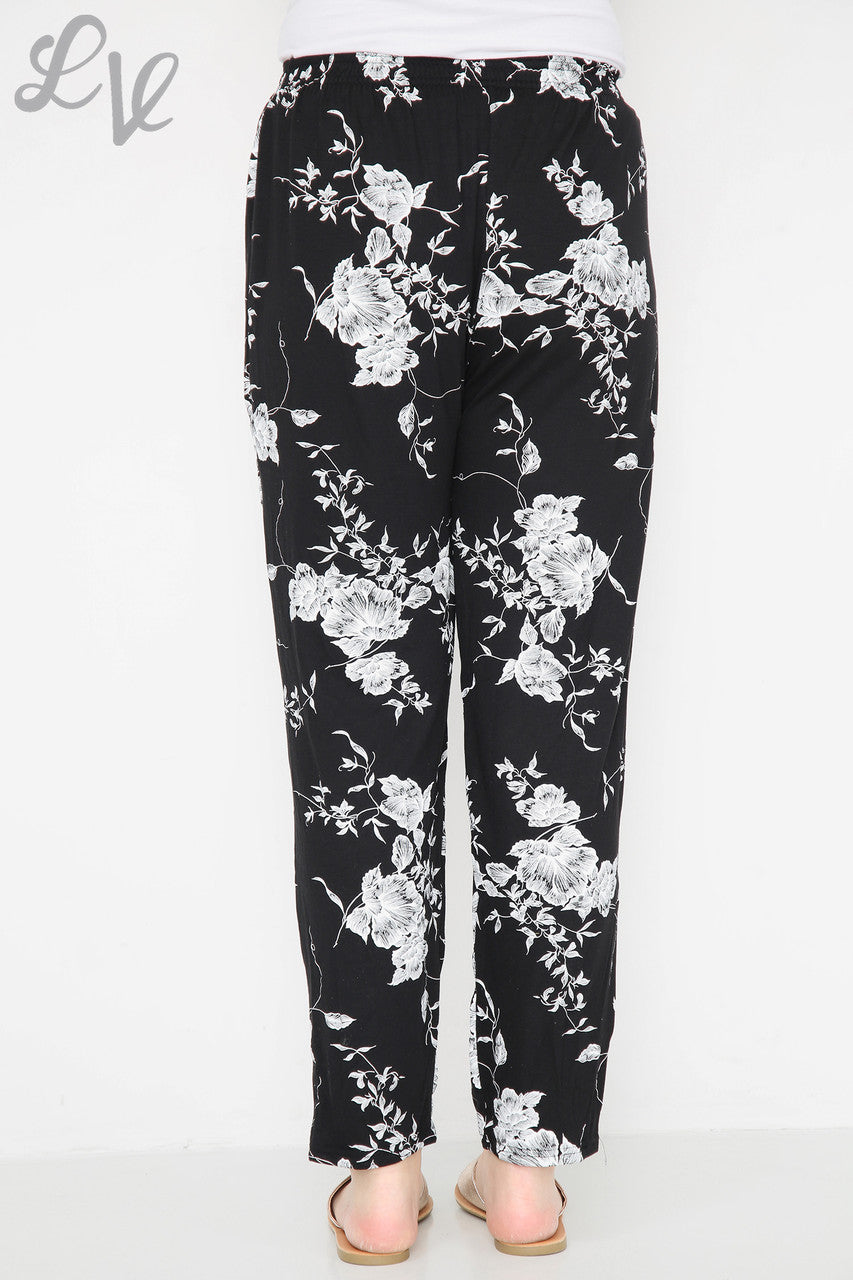Damesbroek met bloemen en bladprint Zwart