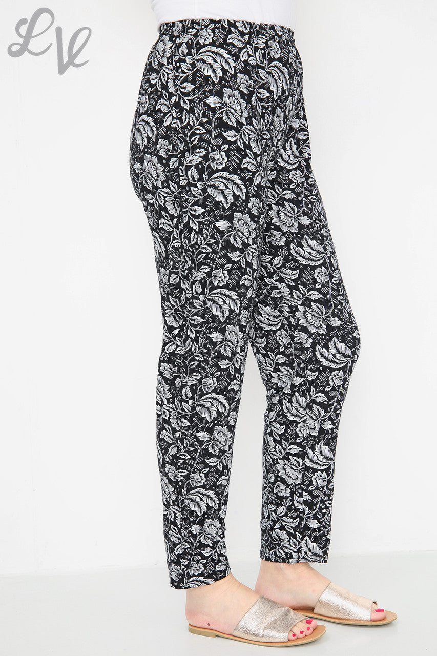 Black leaf-outline print trousers with elastic waist and relaxed straight fit