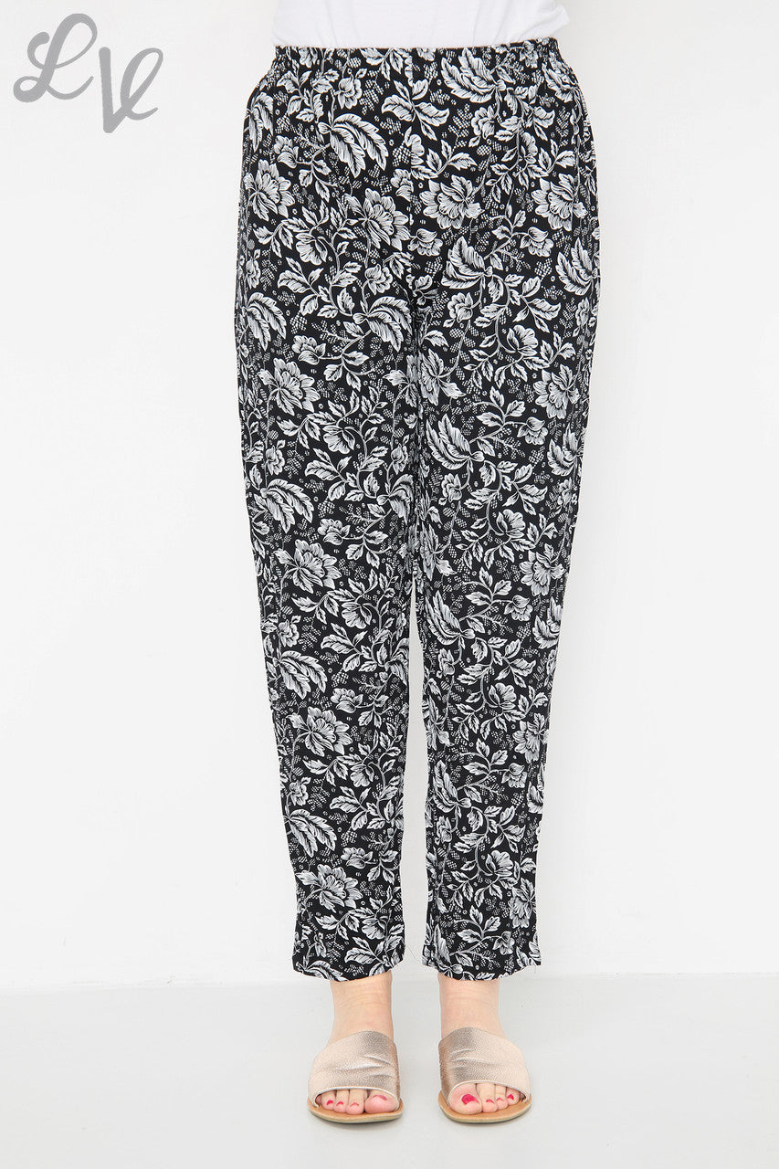 Black leaf-outline print trousers with elastic waist, ankle-length straight legs