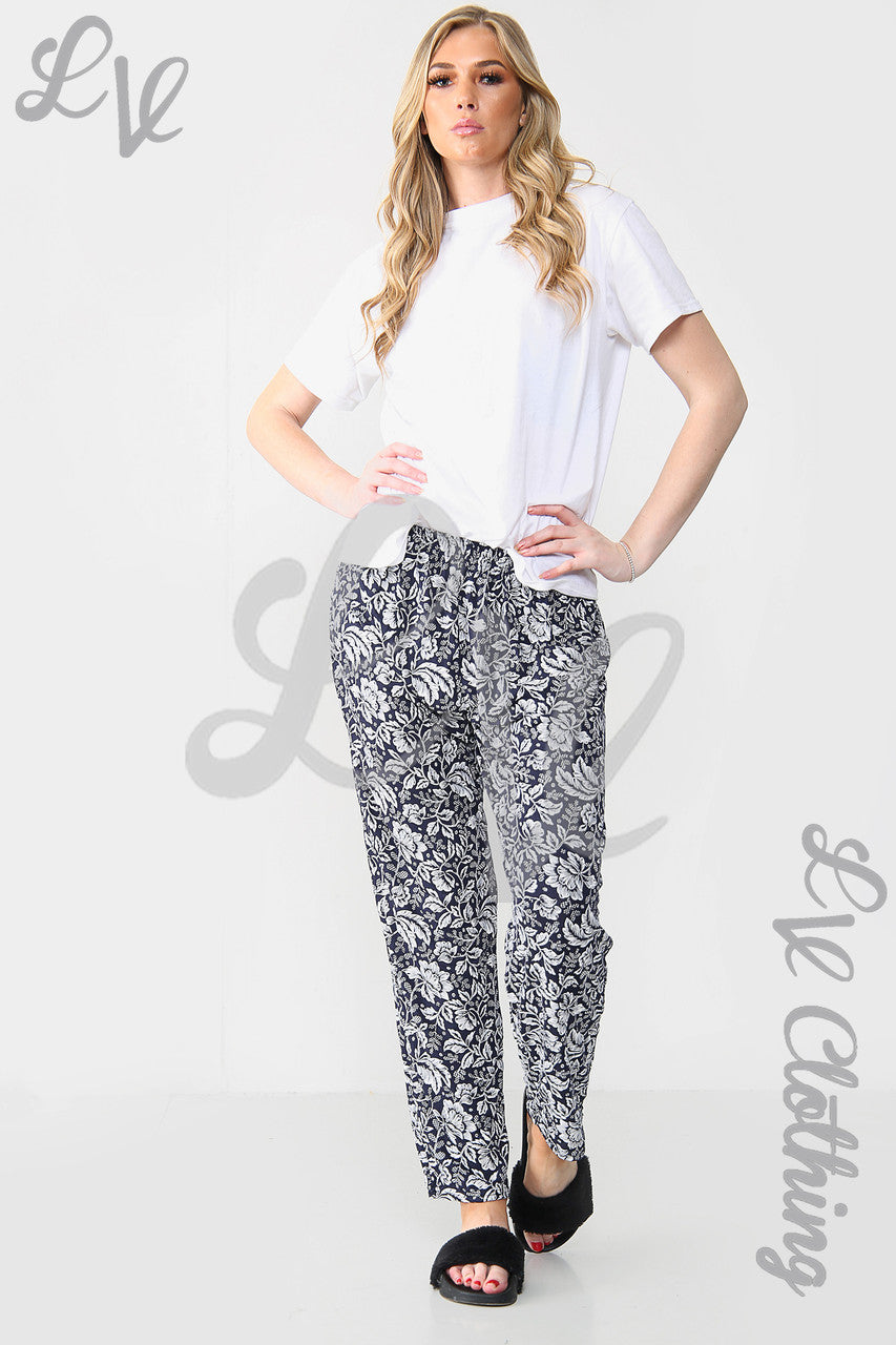 Navy leaf-outline print trousers with relaxed fit and elastic waist