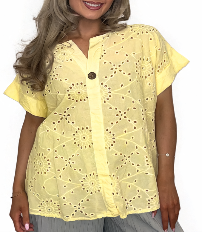 Eyelet embroidered tunic top in yellow with short sleeves and button front, relaxed fit