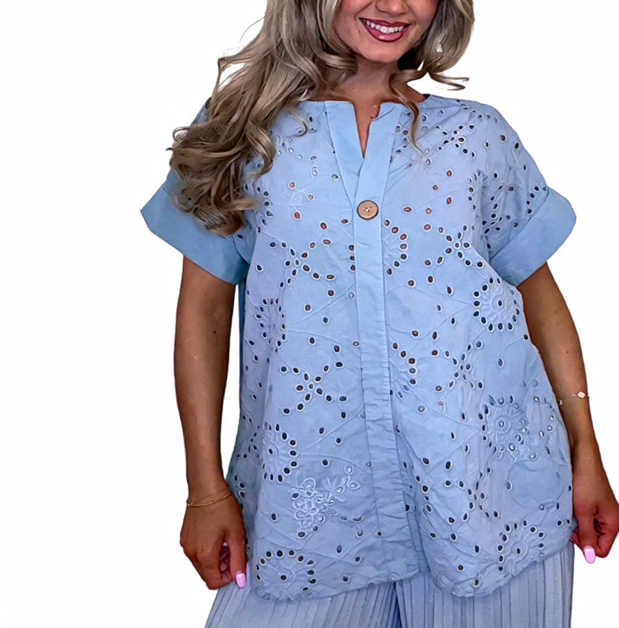 Eyelet embroidered tunic top in light blue with short sleeves and button front, relaxed fit