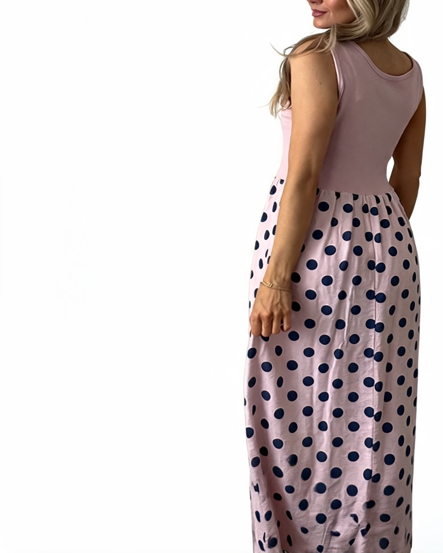 Dusty-rose sleeveless maxi dress with navy polka-dot gathered skirt, side profile