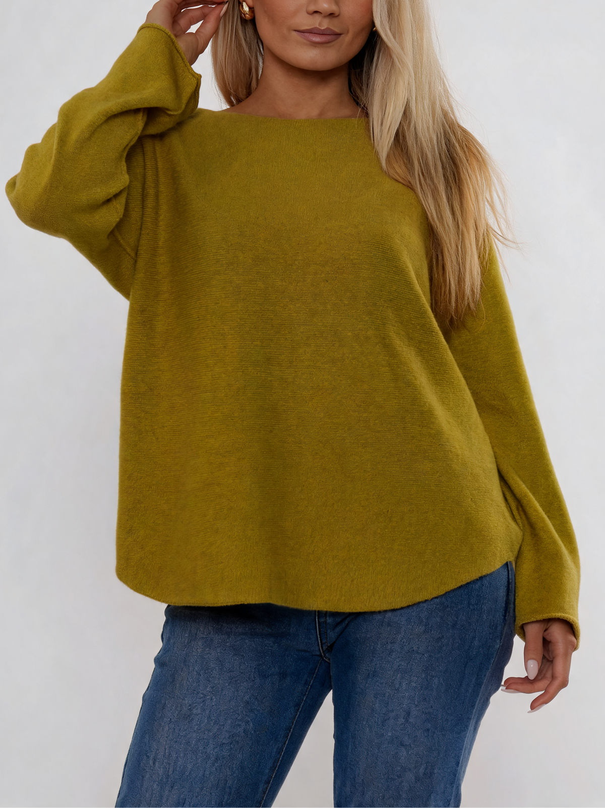 Mustard yellow soft knit boat-neck sweater with curved relaxed fit and long sleeves