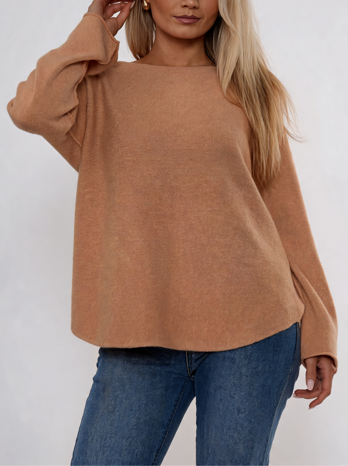 Tan boat neck knit sweater with long sleeves and relaxed curved hem