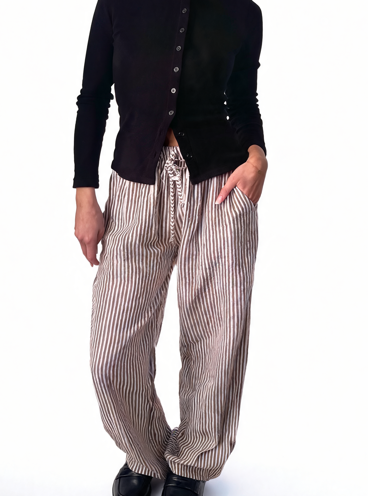 Silver-and-white striped wide-leg drawstring trousers with tied waist cord