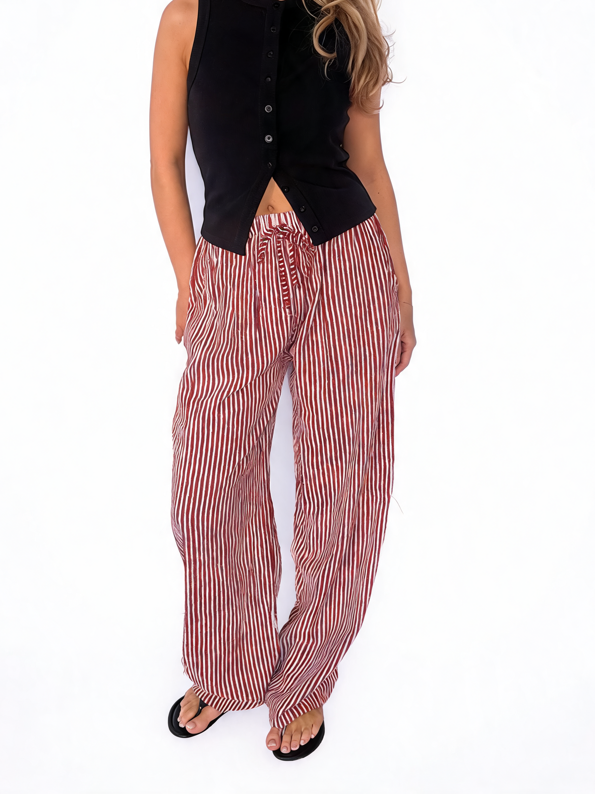 Striped wide-leg drawstring trousers with red-and-white vertical stripes, side view