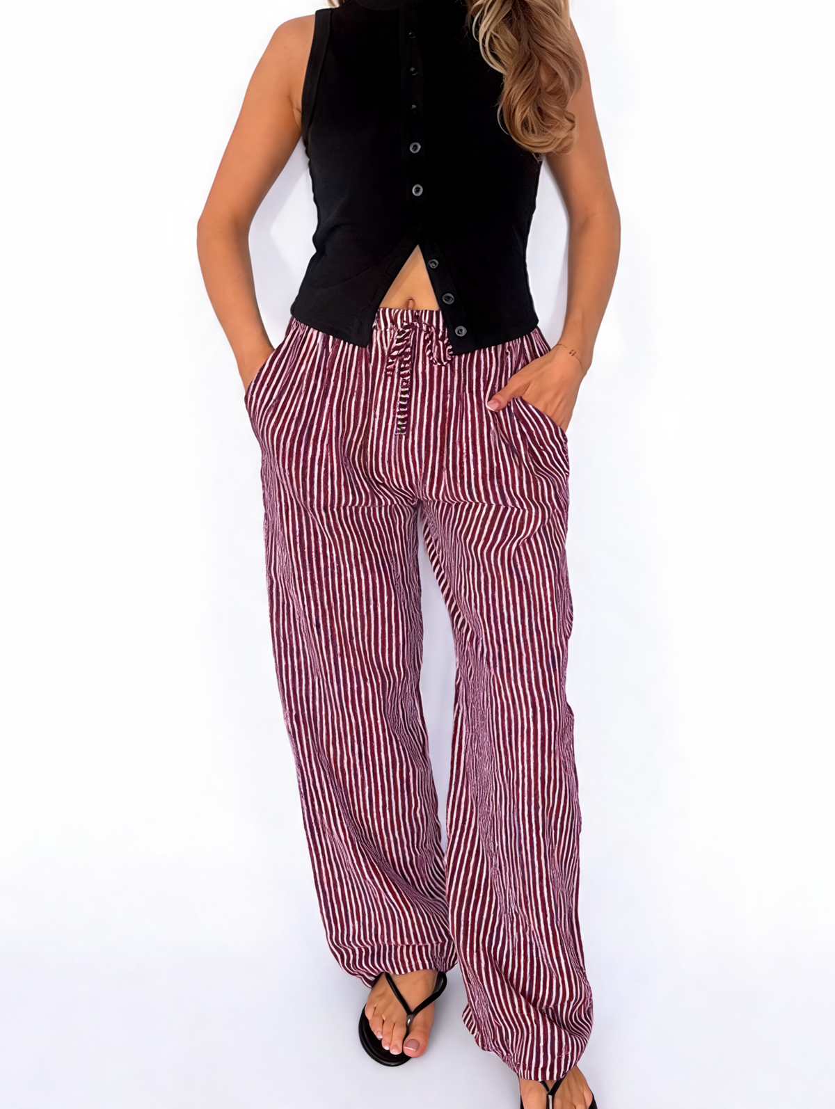 Striped wide-leg drawstring trousers in burgundy-and-white vertical stripes, front view