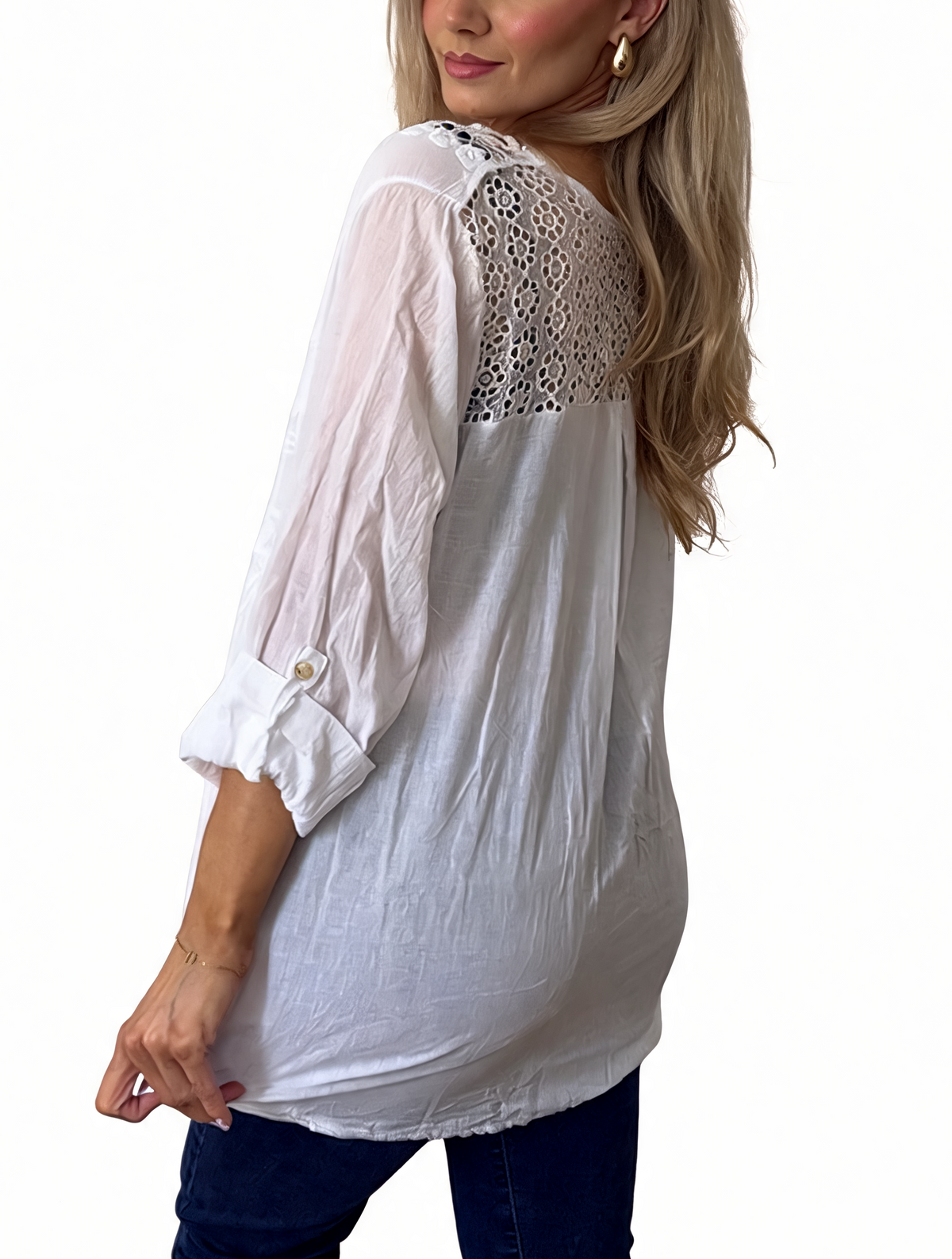 White embroidered babydoll top with crochet lace shoulder detail and ruffled cuff sleeves