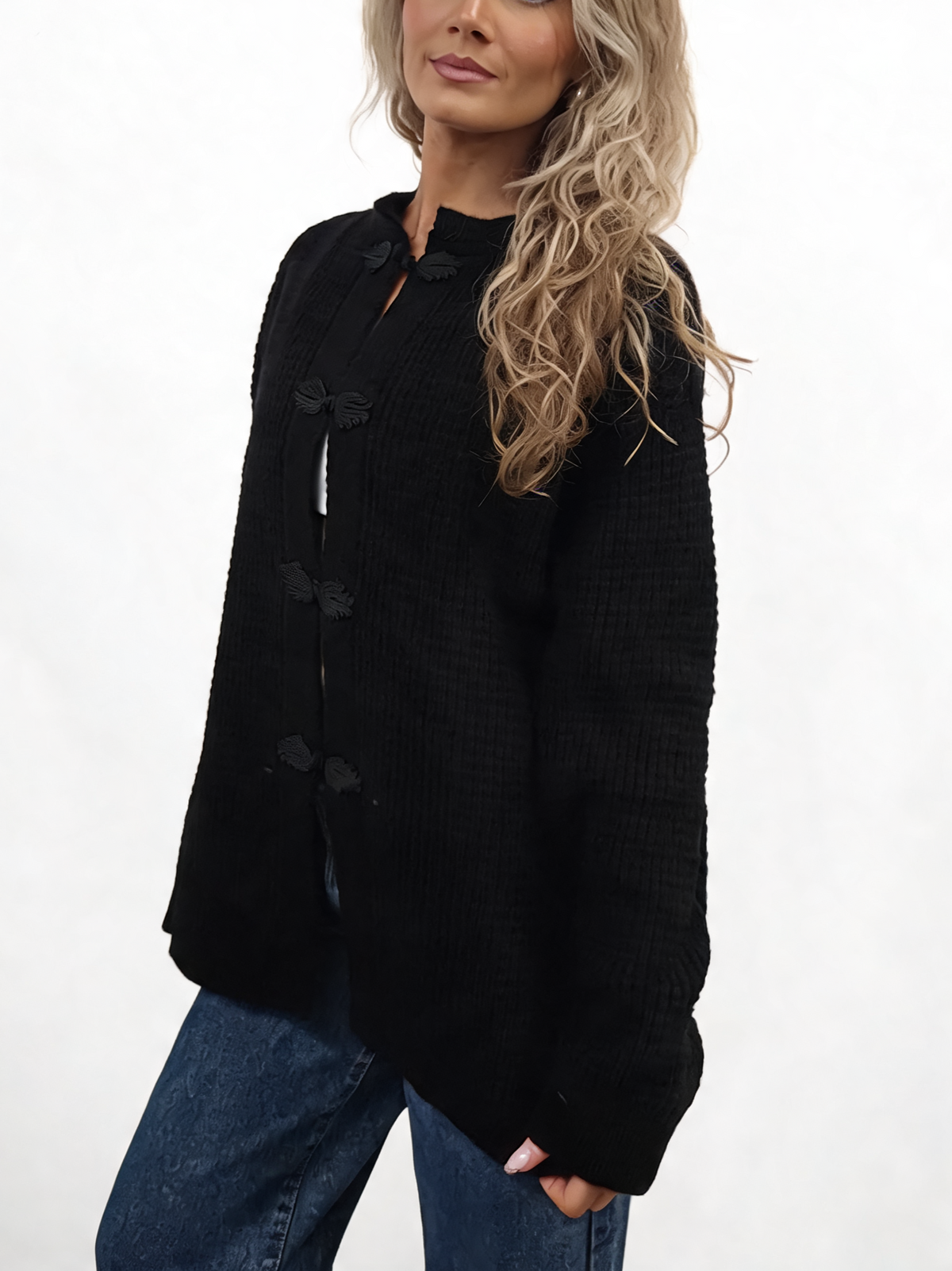 Black chunky waffle-knit cardigan with frog buttons and long sleeves